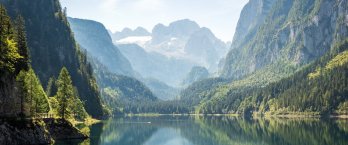 Mountain lake among jagged peaks and alpine forest in Austria